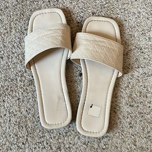 Pinkish beige, single strap flip flops.